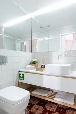 a white bathroom with a toilet and a sink at Get a Golden and Flower Flat in Porto