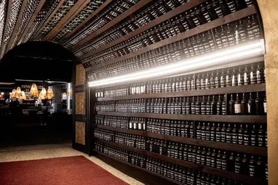 a room with a wall of wine bottles at Rubens Hotels & SPA in Vila Nova de Gaia