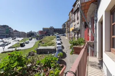 a row of cars parked on the side of a street at OPO 52 in Porto