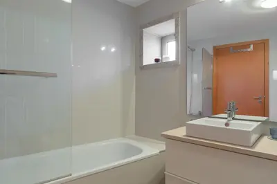 a bathroom with a sink and a tub and a mirror at OPO 52 in Porto