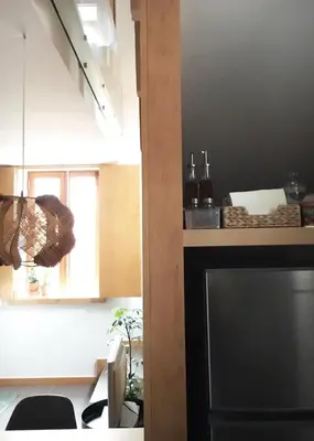 a kitchen with a black refrigerator and a window at Casa do Bairro 2 in Porto