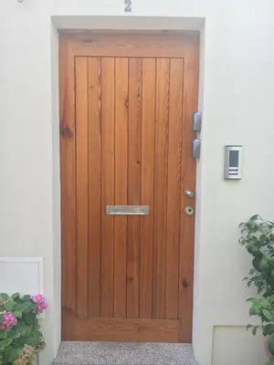 a wooden door leading into a building at Casa do Bairro 2 in Porto