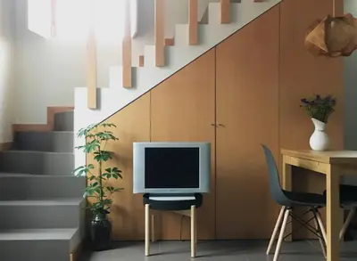 a desk with a computer on a chair next to a staircase at Casa do Bairro 2 in Porto
