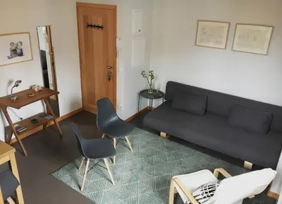 a living room with a couch and chairs and a table at Casa do Bairro 2 in Porto
