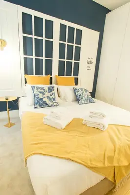 a white bed with towels on top of it at Janelas de São Bento by Porto City Hosts in Porto