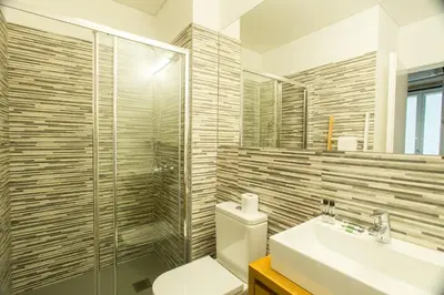 a bathroom with a toilet and a sink and a shower at Janelas de São Bento by Porto City Hosts in Porto
