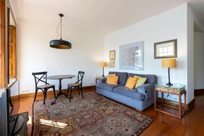 a living room with a couch and a table at Porto Premium River View I in Porto