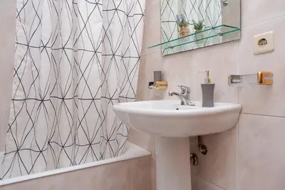a bathroom with a sink and a mirror at Sunny view to the Tower in Porto