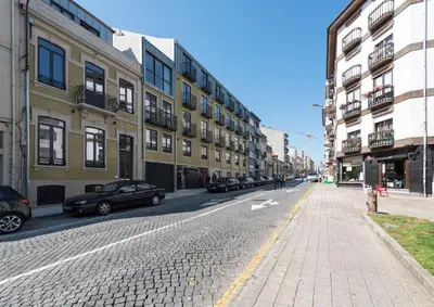 a city street with buildings and cars parked on the street at LovelyStay - Downtown Balcony Apartment with Free Parking in Porto