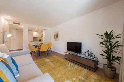 a living room with a couch and a flat screen tv at LovelyStay - Downtown Balcony Apartment with Free Parking in Porto