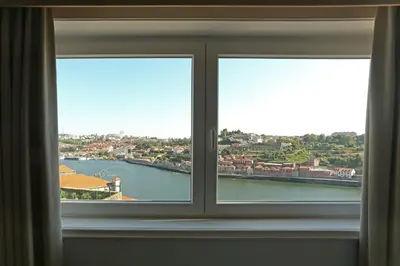 a window with a view of a body of water at Villa D'Ouro in Porto