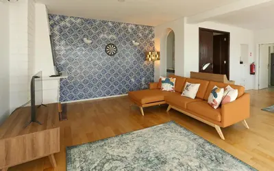 a living room with a couch and a tv at Villa D'Ouro in Porto