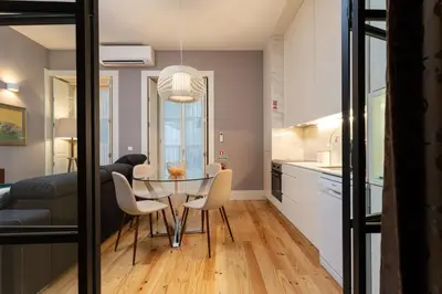 a dining room and kitchen with a table and chairs at Porto Garden Studio - Santa Catarina in Porto