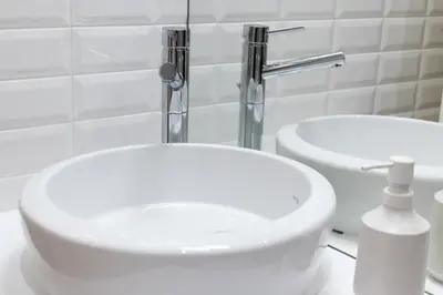 a white bathroom with two sinks and a faucet at Porto Garden Studio - Santa Catarina in Porto