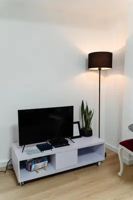 a white entertainment center with a flat screen tv on it at River Flat I - Heart of Porto in Porto