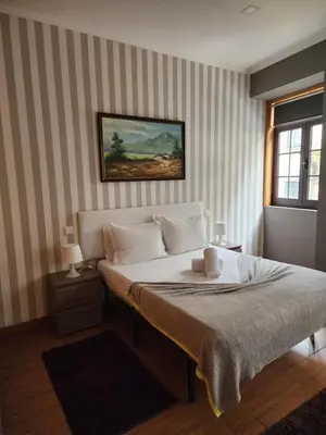 a bedroom with a large white bed in a room at D'OURO DONA MARIA By LW in Vila Nova de Gaia