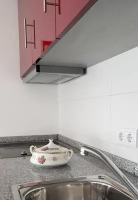 a kitchen counter with a sink and a vase on it at D'OURO DOM LUÍS By LW in Vila Nova de Gaia