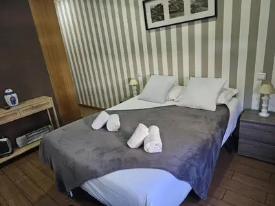 a bedroom with a large bed with white sheets and pillows at D'OURO DOM LUÍS By LW in Vila Nova de Gaia