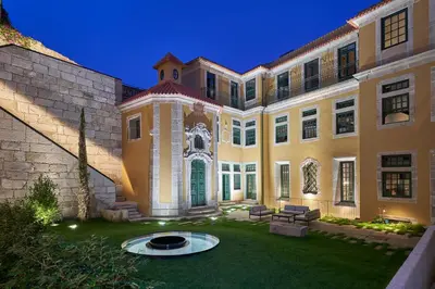 a large building with a lawn in front of it at PortoBay Flores in Porto