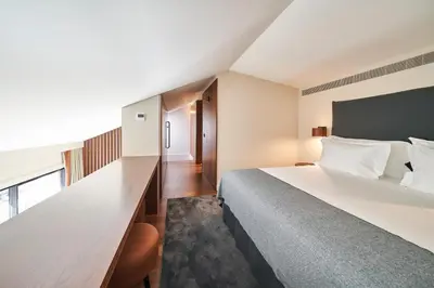 a bedroom with a large bed and a large window at PortoBay Flores in Porto