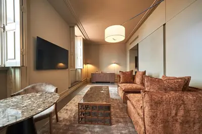 a living room with a couch and a tv at PortoBay Flores in Porto