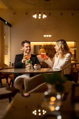 a dining room with a table and chairs with food on it at PortoBay Flores in Porto