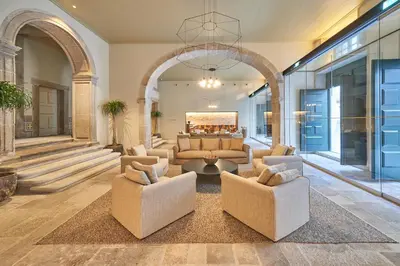 a large living room with a couch and chairs at PortoBay Flores in Porto
