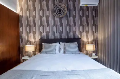 a bedroom with a large bed with two lamps at Firmeza388 Charming Flats - Comfort & Privacy with 2 Bedrooms in Porto