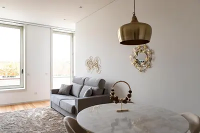 a dining room with a table and a vase of flowers at Porto Deluxe Apartments in Porto