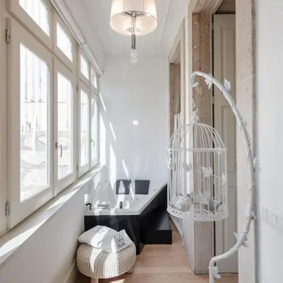 a white bedroom with a bed and a tv at Porto Deluxe Apartments in Porto