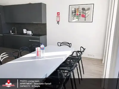 a kitchen with a white table and black chairs at Downtown Fantail in Porto