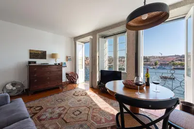 a living room with a table and a couch at Porto Premium River View II in Porto