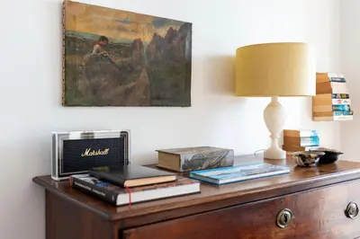 a table with a lamp and a painting on the wall at Porto Premium River View II in Porto