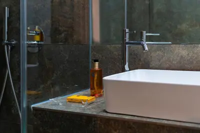 a bathroom with a sink and a glass shower at Porto Premium River View II in Porto