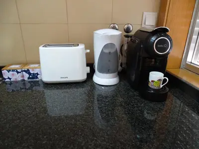 a coffee maker and a coffeemaker sitting on a counter at Porto City Experience in Porto