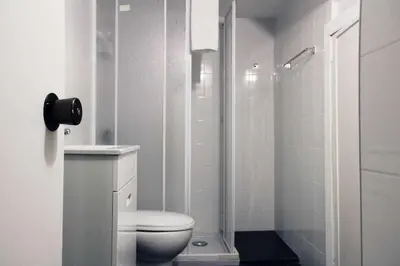a white bathroom with a toilet and a shower at Panorama Apartments Ribeira Gaia in Vila Nova de Gaia
