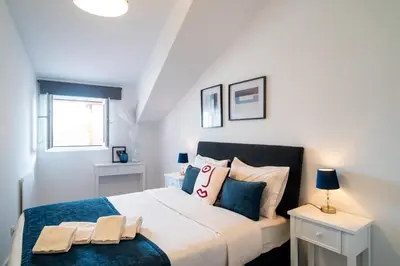 a bedroom with a large white bed with pillows at River Flat IV - Heart of Porto in Porto