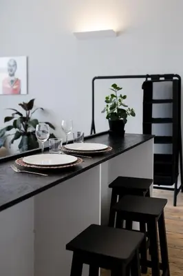 a counter with two glasses of wine and two stools at Baixa24 •P2R• Bright Apt in Vibrant Downtown in Porto