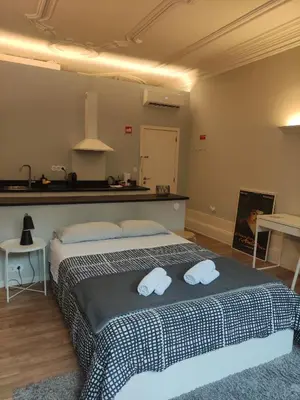 a bedroom with a bed with two towels on it at Baixa24 •P1R• Brand New Apt in the Historic Center in Porto
