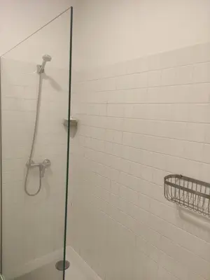 a shower in a bathroom with a glass door at Baixa24 •P1R• Brand New Apt in the Historic Center in Porto