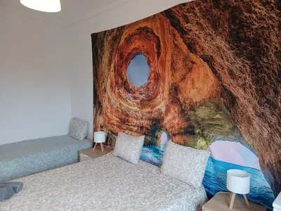 a bedroom with a mural on the wall at Oporto Cozy Rooms in Porto