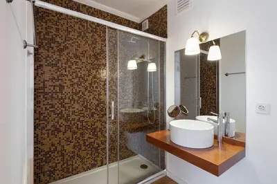 a bathroom with a sink and a glass shower at LovelyStay - Penthouse Balcony Apartment in Porto