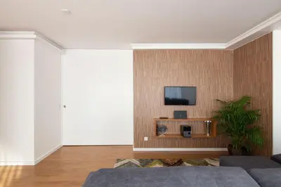 a living room with a tv on a wall at LovelyStay - Penthouse Balcony Apartment in Porto