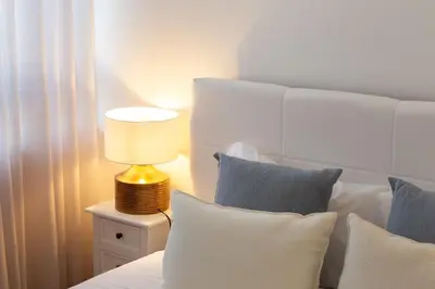 a bedroom with a bed with a lamp on a night stand at LovelyStay - Penthouse Balcony Apartment in Porto