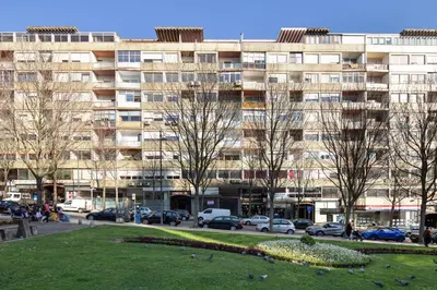 a large building with cars parked in front of it at LovelyStay - Penthouse Balcony Apartment in Porto