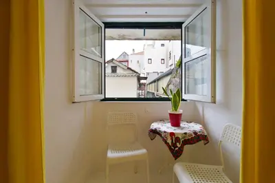 a table and two chairs in a room with a window at Oporto Blue Trindade - Magical Citycenter Apartment in Porto