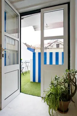 an open door with a potted plant next to it at Oporto Blue Trindade - Magical Citycenter Apartment in Porto