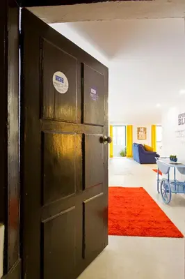 an open door to a living room with a red rug at Oporto Blue Trindade - Magical Citycenter Apartment in Porto