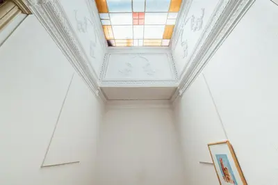 a room with a ceiling with a stained glass window at SwissPorto Guest House in Porto