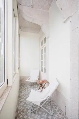 a white bedroom with a bed and a table and chairs at Palace Museum & National Monument - Espaço Palmeiras in Porto